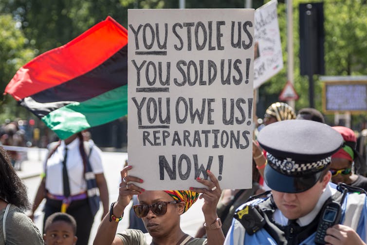 Protestors hold up placards on a march.