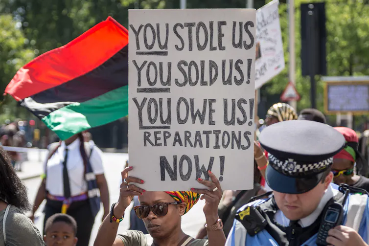 Protestors hold up placards on a march.