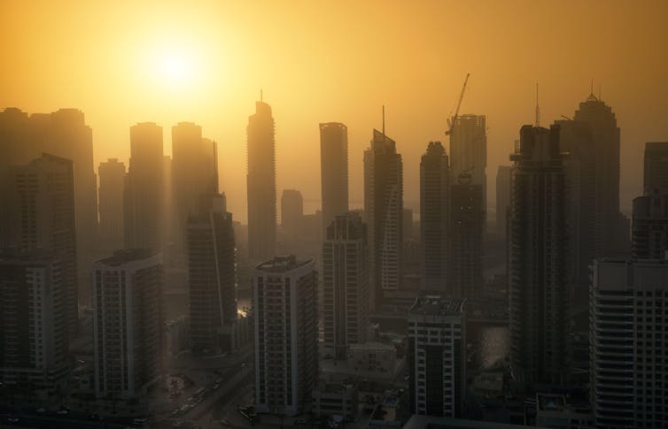 The Dubai city skyline at dusk.