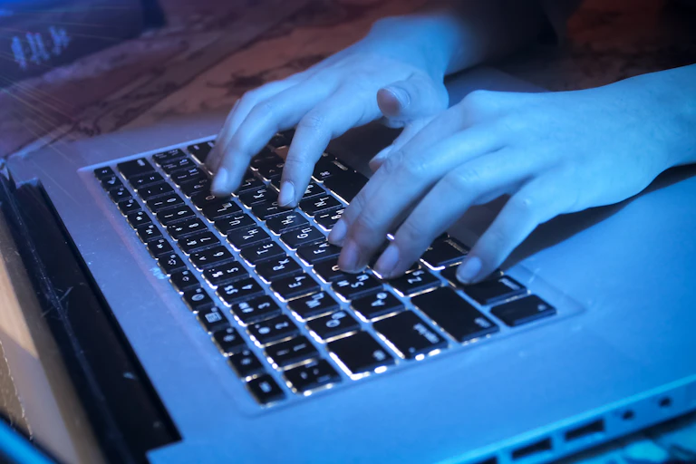 Hands seen at a keyboard.