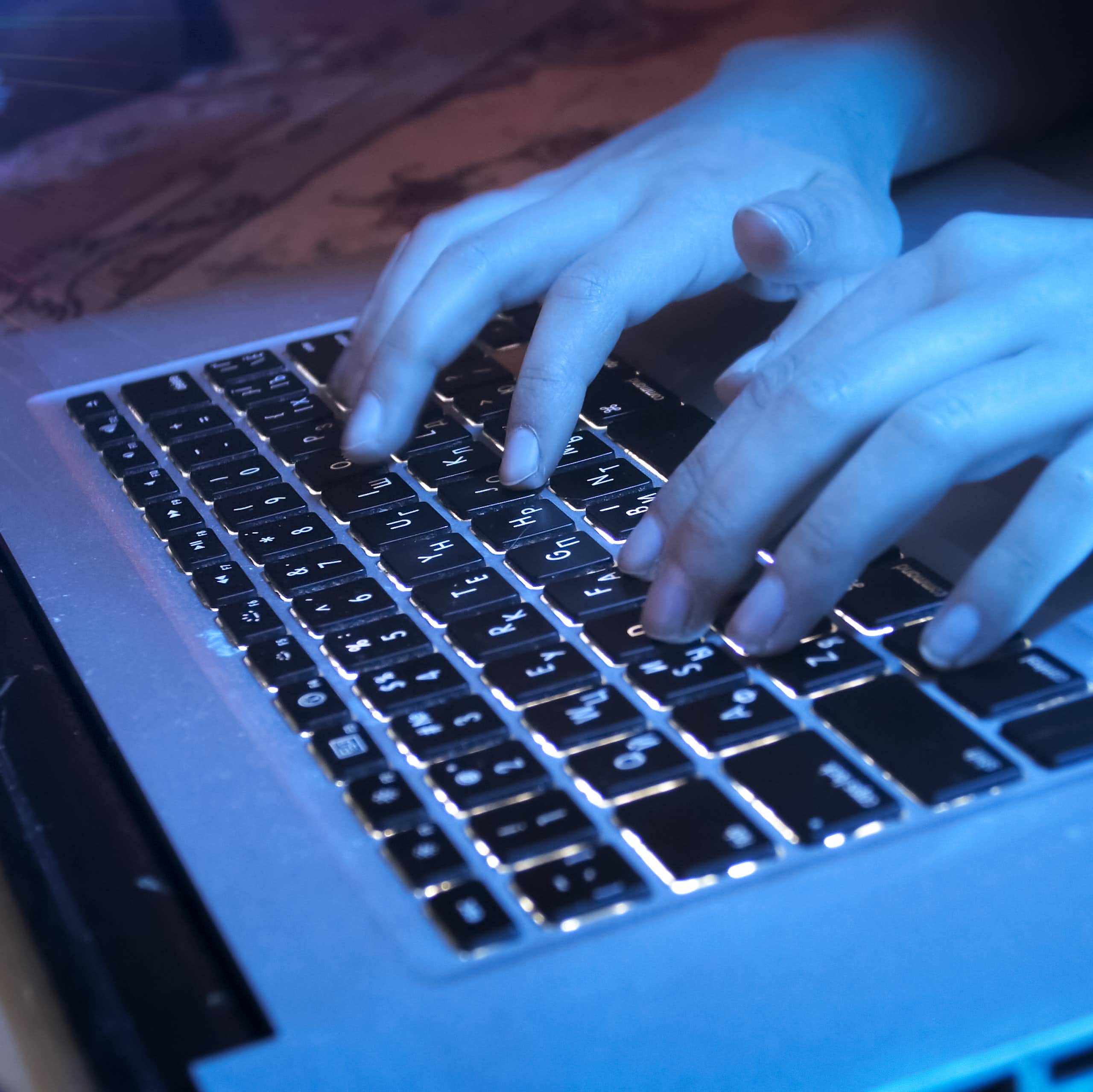 Hands seen at a keyboard.