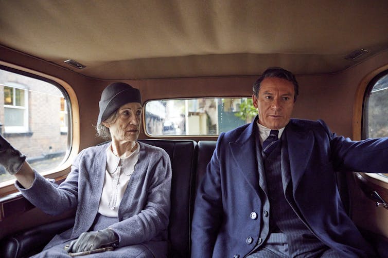 Jason Isaacs as Cary Grant and Harriet Walter as Elsie sat in a car.