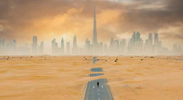 road to dubai covered in sand, big city, 