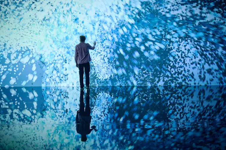 A body in front of blue lights.