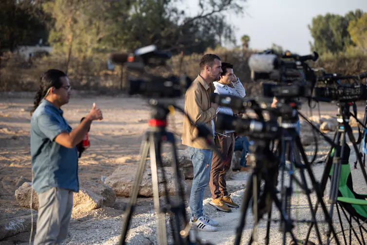 A row of TV reporters doing live crosses in Gaza