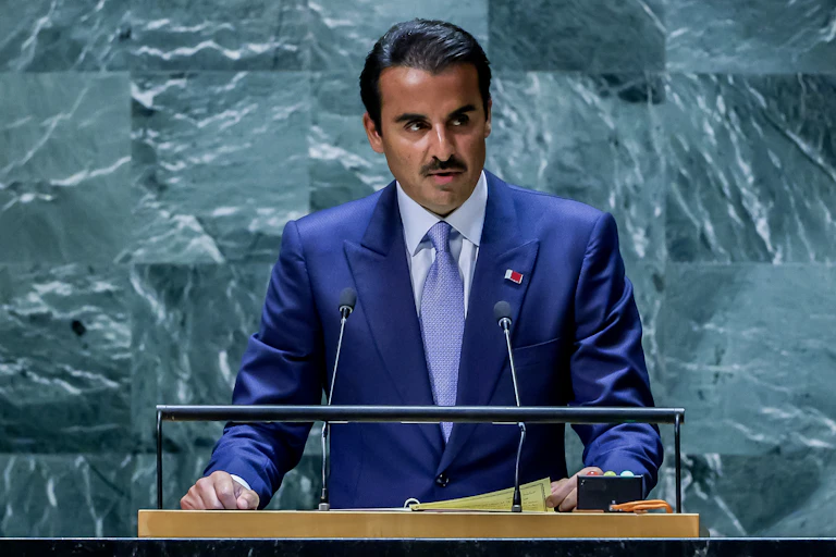 Emir of Qatar, Sheikh Tamim bin Hamad Al Thani delivers a speech standing at a lecturn.