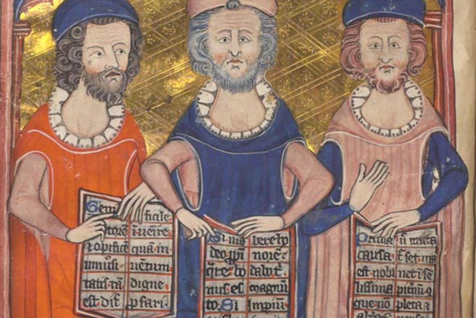 three men holding scripts.