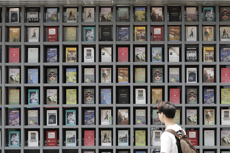 Rapaz observa uma vitrine cheia de livros
