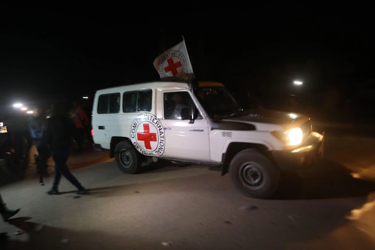 A white van with a Red Cross on it.