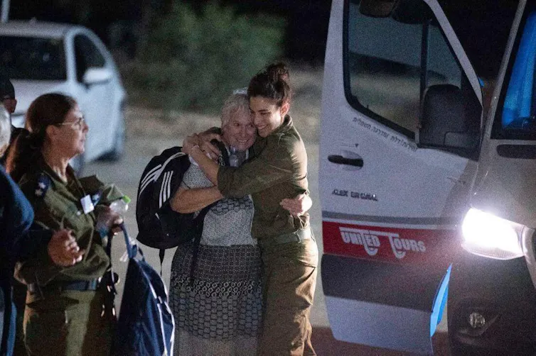 A woman hugging a soldier in Israeli uniform.