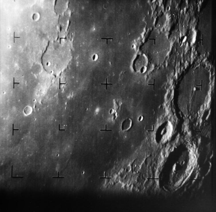Grey and white craters on the lunar surface.