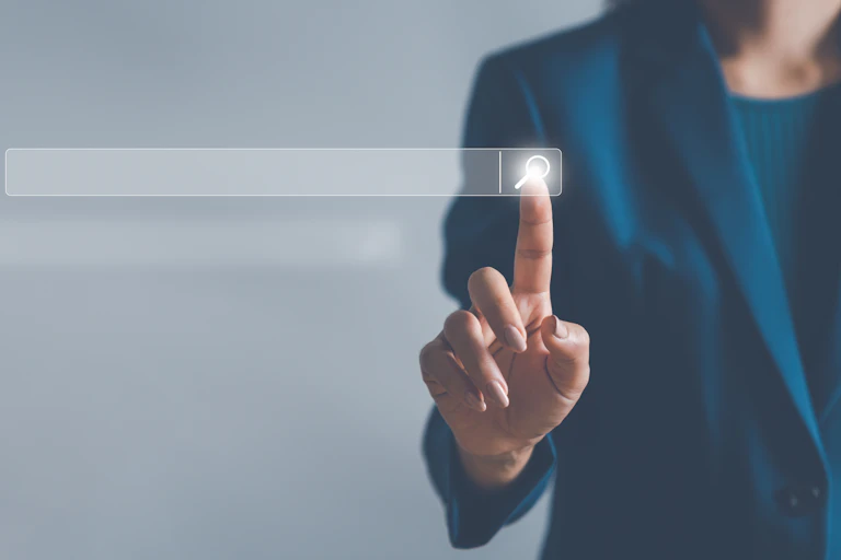 woman's finger touching search icon on a screen