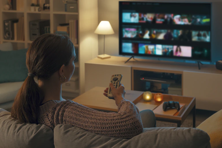 A woman watches TV
