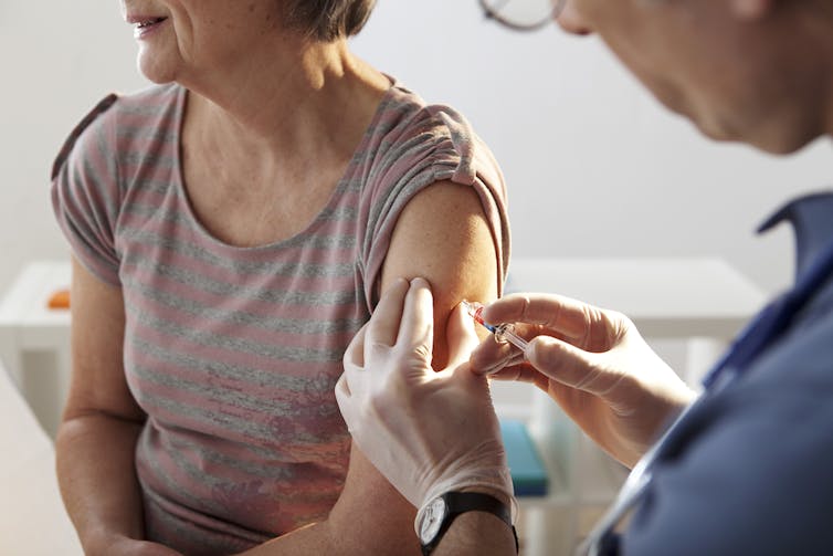 Older adult receiving a flu vaccine.