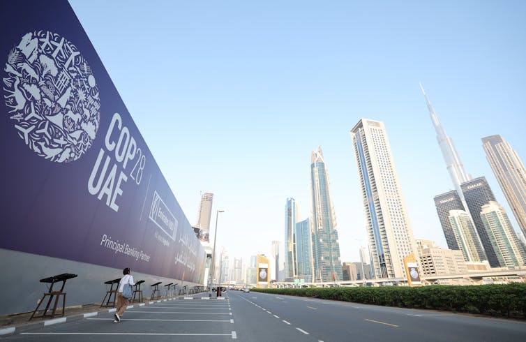 COP28 sign with Dubai skyline in background