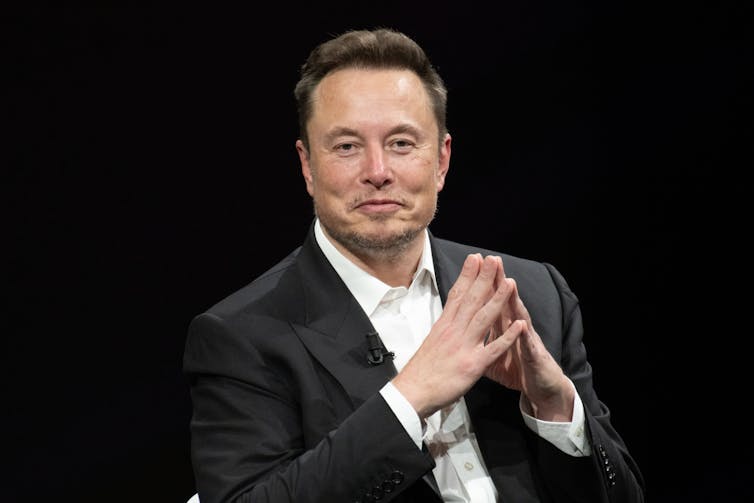 Elon Musk looking directly at the camera.