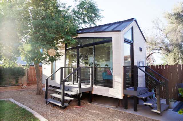 A modern tiny house in a suburban backyard
