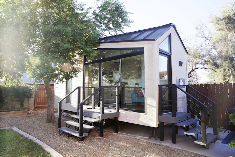 A modern tiny house in a suburban backyard