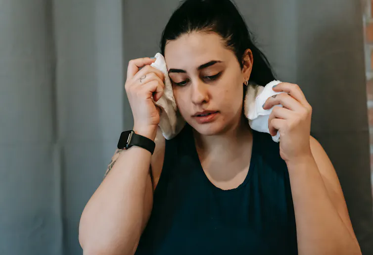 Hot woman wipes sweat