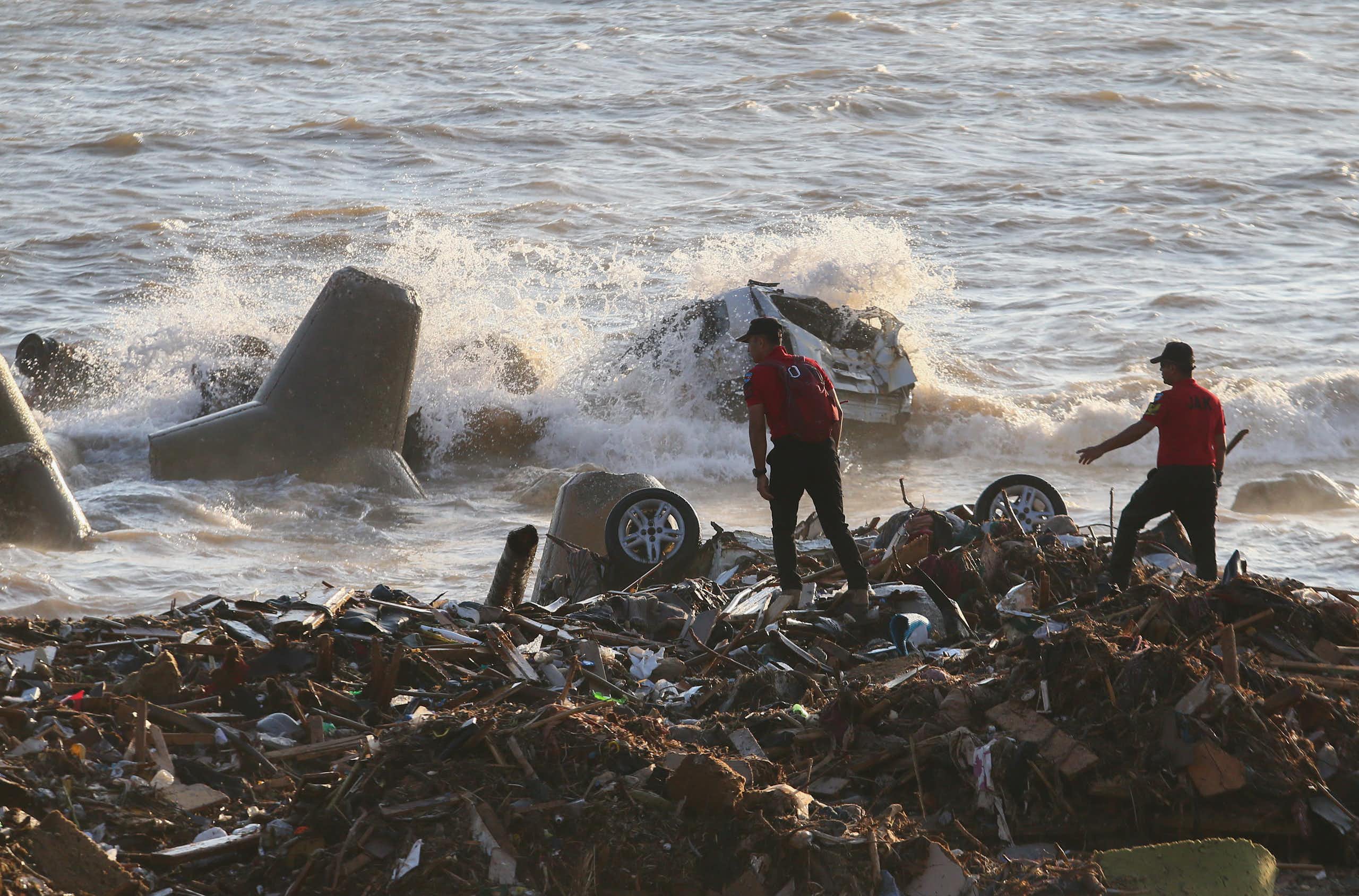 Men searching through debris.