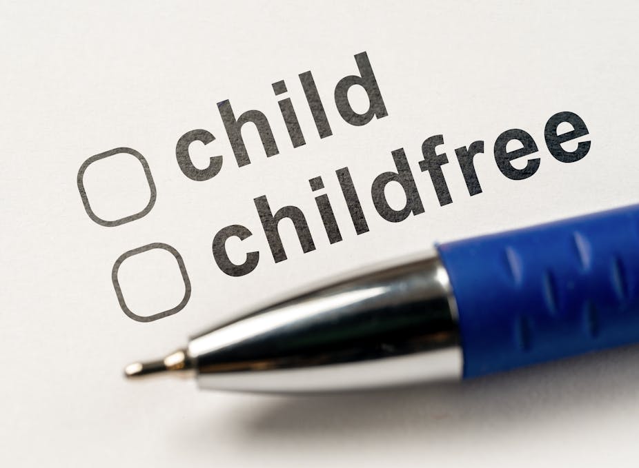 A pen resting on a piece of paper with two checkboxes, one for a child or childfree. 