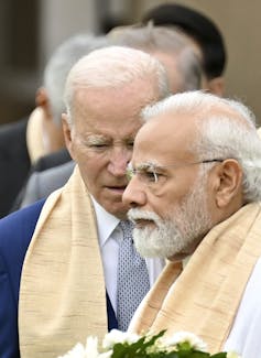 Narendra Modi with Joe Biden standing in the background