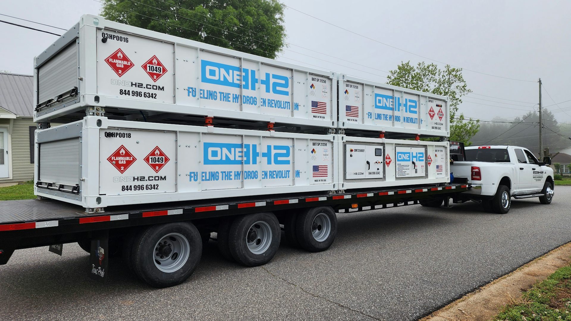 A vehicle tows a trailer carrying equipment for a hydrogen refuelling station.