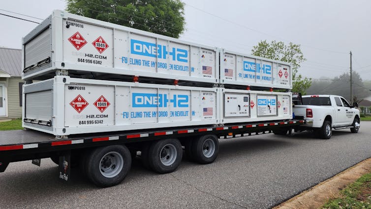 A vehicle tows a trailer carrying equipment for a hydrogen refuelling station.
