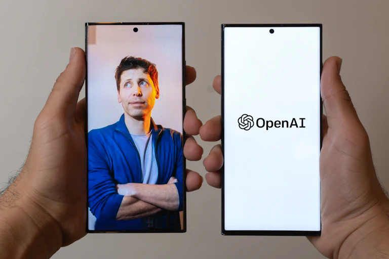 Two phones showing images of Sam Altman and OpenAI brand.