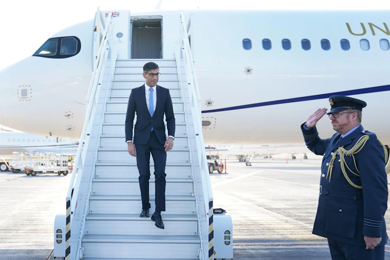 Rishi Sunak on steps of a plane