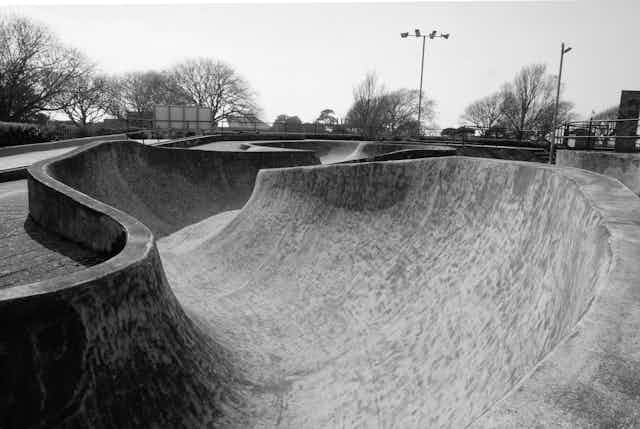 A black and white photograph of a skatepark.
