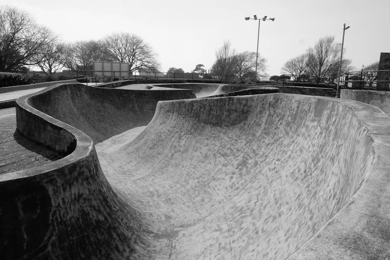 A black and white photograph of a skatepark.