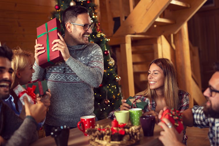 Friends exchange gifts.
