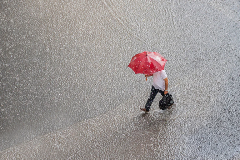 heavy rain, man walking