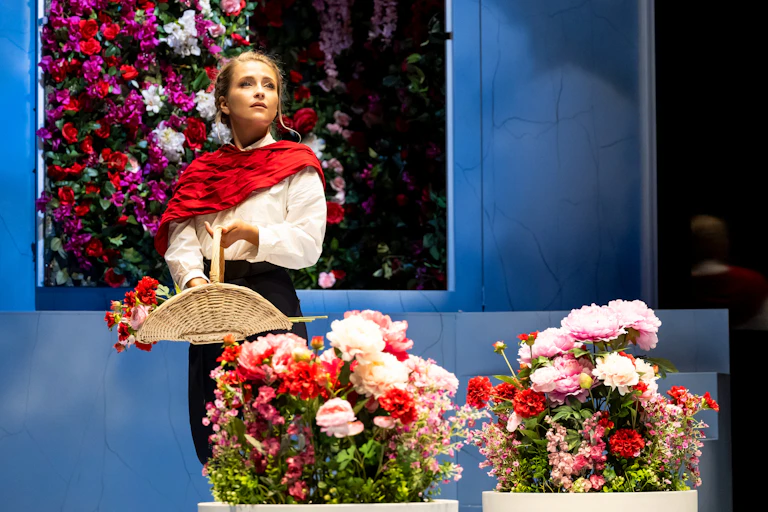 A woman surrounded by flowers.