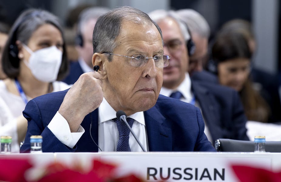 Russia's foreign minister, Sergei Lavrov, scowls as he adjusts his earpiece at the ister, Sergei Lavrov, at the OSCE ministers' meeting in North Macedonia on November 30.