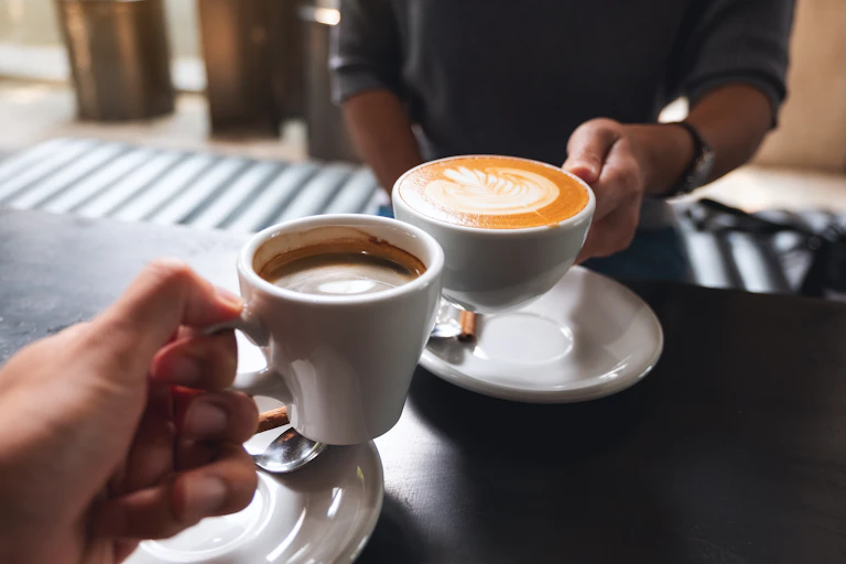 Hands holding cups of coffee