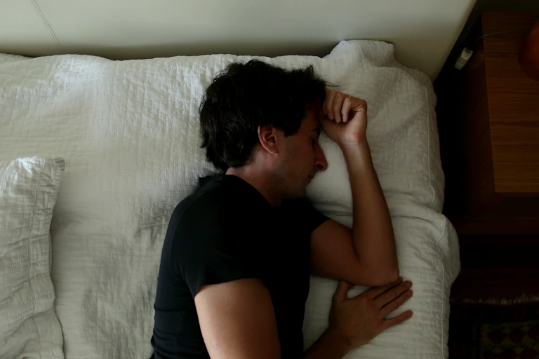 A young man resting in bed.