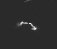 Black and white image of a star field with a hazy white ribbon in the centre