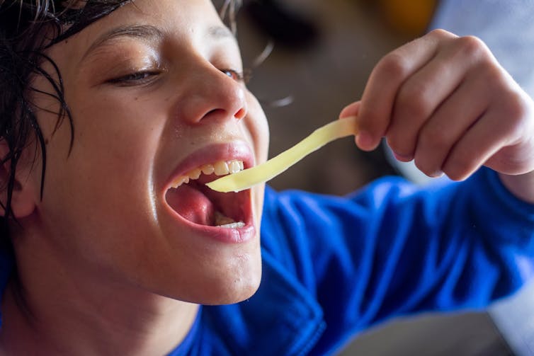 Older child eating spicy soup.