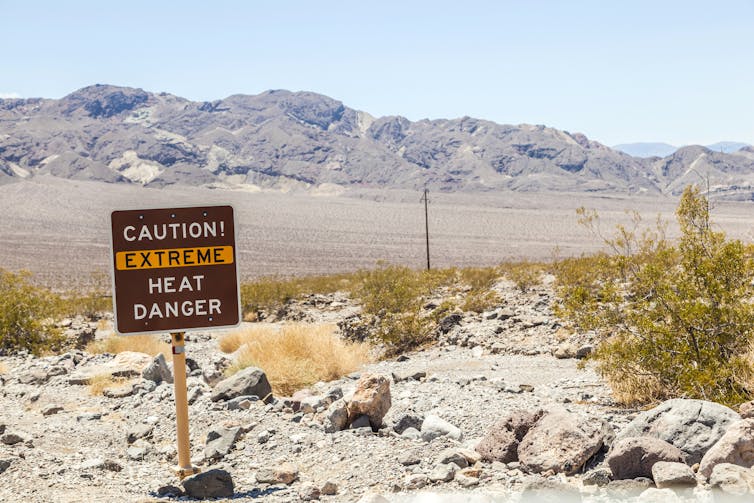 Heat danger sign, desert background