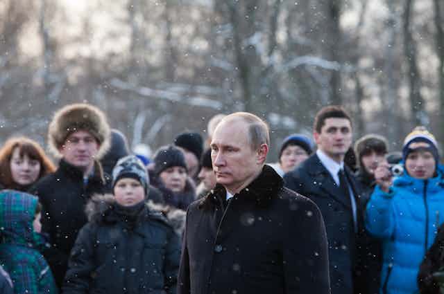 President of the Russian Federation Vladimir Putin at the Piskarevsky Cemetery laying flowers at the World War II memorial in January 2014.