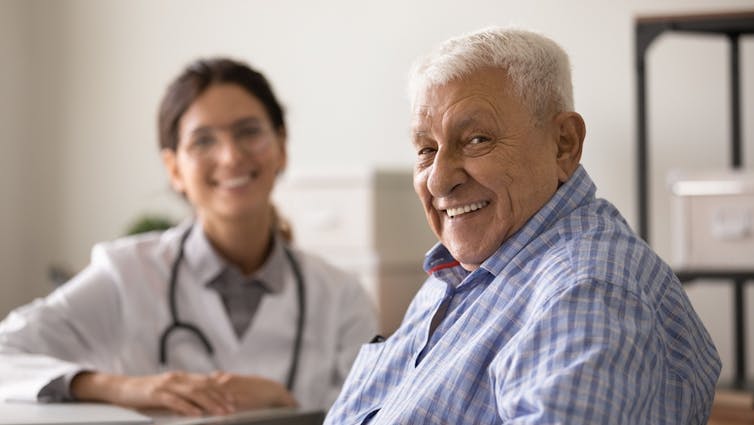 A female doctor and an elderly male patient.