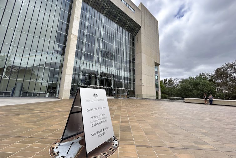 The exterior of the High Court of Australia behind a small metal sign