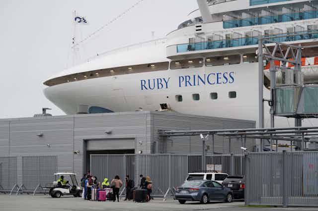 A close-up of 'Ruby Princess' written on the side of a cruise ship