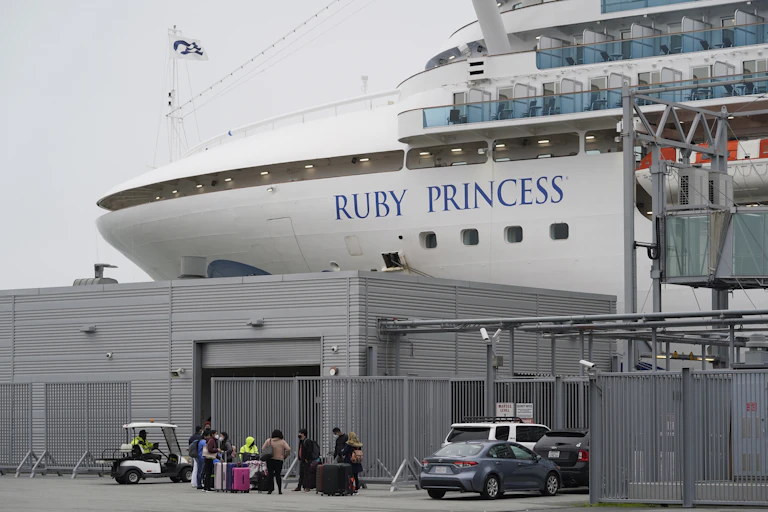 A close-up of 'Ruby Princess' written on the side of a cruise ship