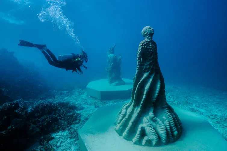 A diver and a sculpture.