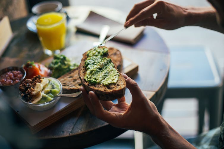 Man spreads avocado