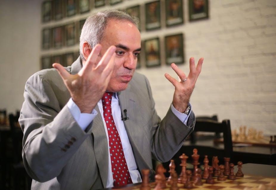 FIDE presidential candidate and former World Chess Champion, Anatoly Karpov,  lower, reacts as former World Chess Champion, Garry Kasparov walks pass  before the start of their World Chess Federation (FIDE) presidential  election