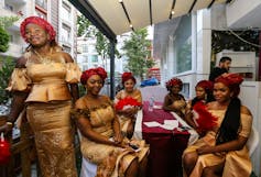 women dressed in similar clothes sit together